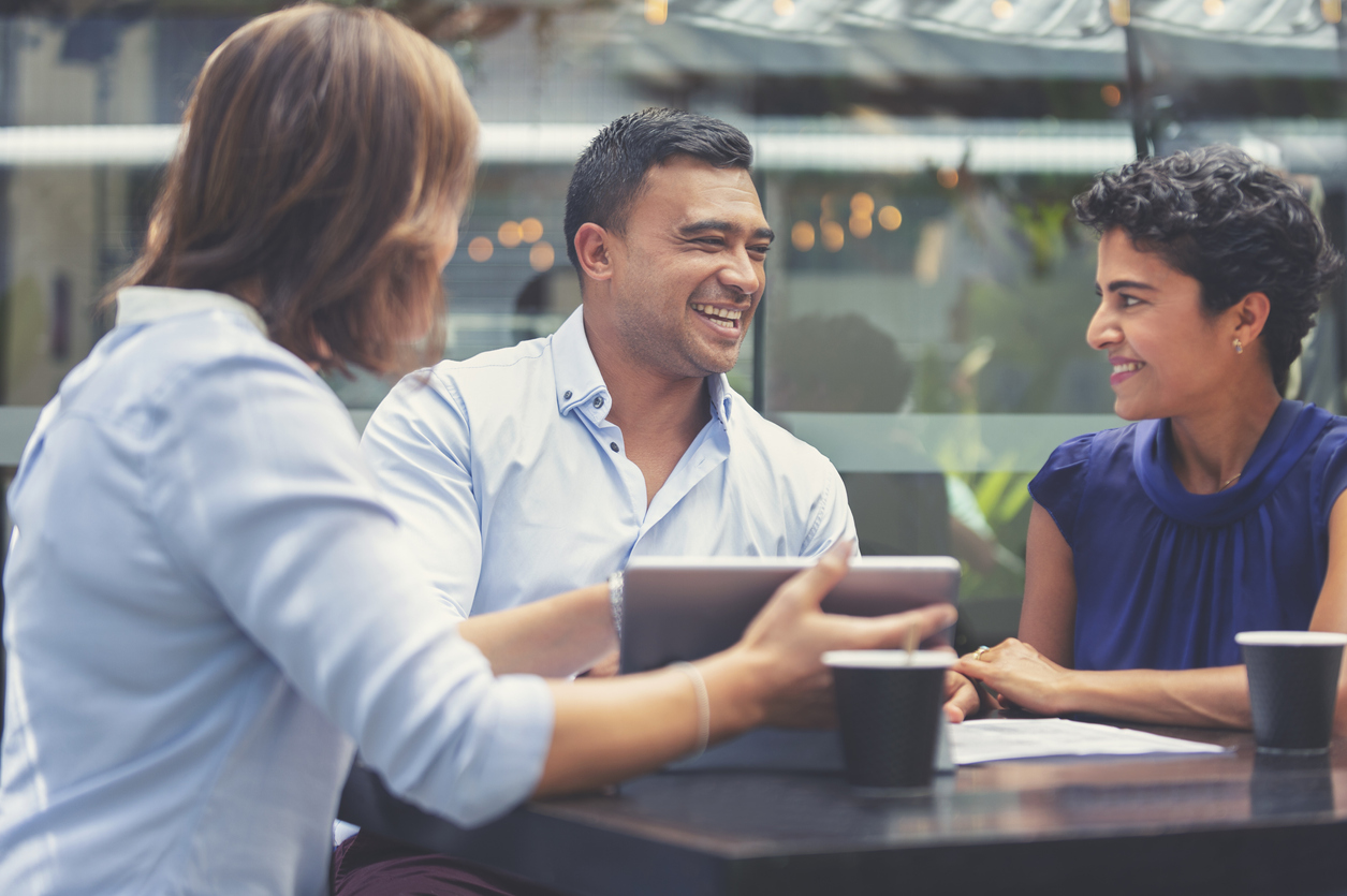 Happy couple having a business meeting with a financial advisor.